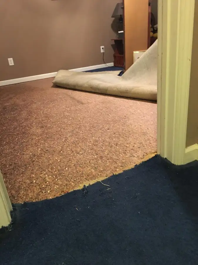 Carpet pad removal revealing water damage during Water Mitigation Services in Waipio Acres